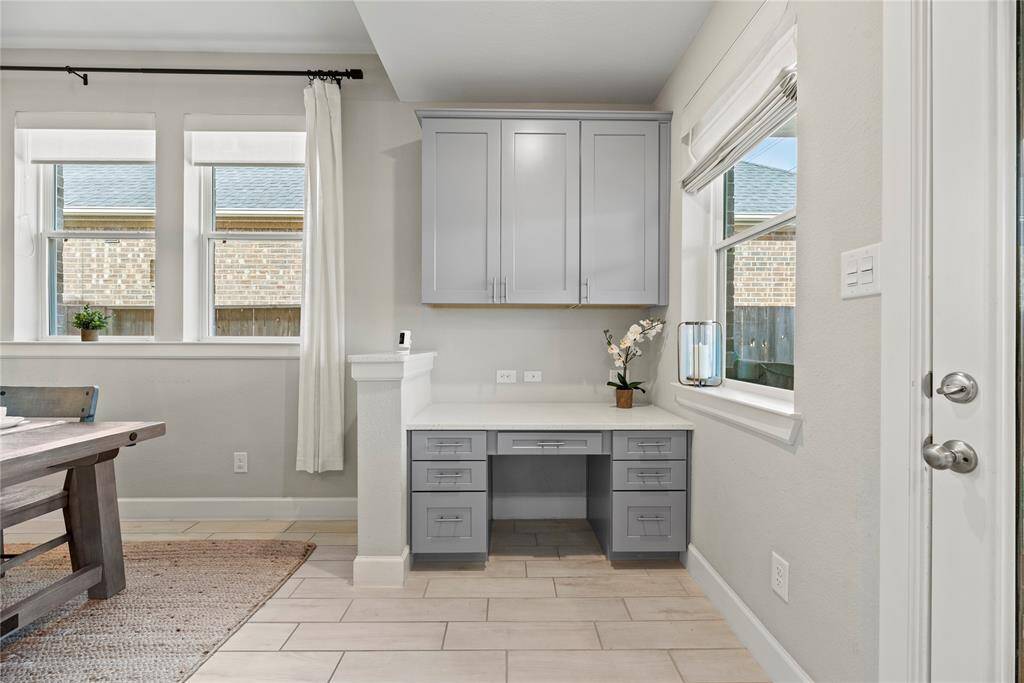 This additional desk area with coordinating counter and cabinet space is great for organizing recipes or homework for the kiddos.