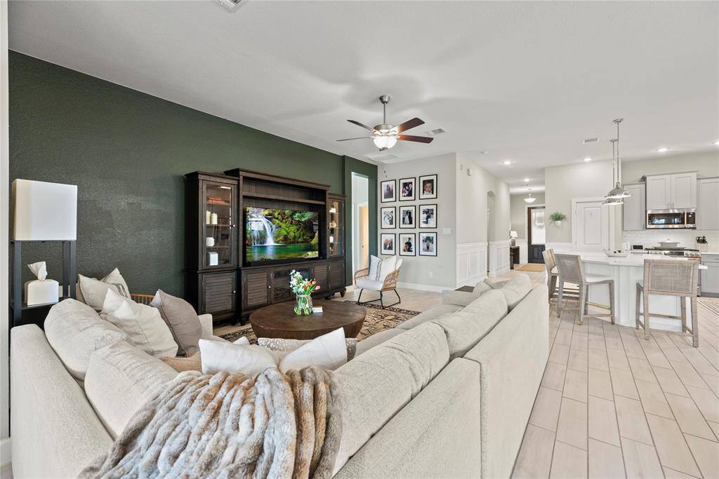 The living room, adjacent to the kitchen and breakfast area, offers a comfortable and inviting space for relaxation and socializing.