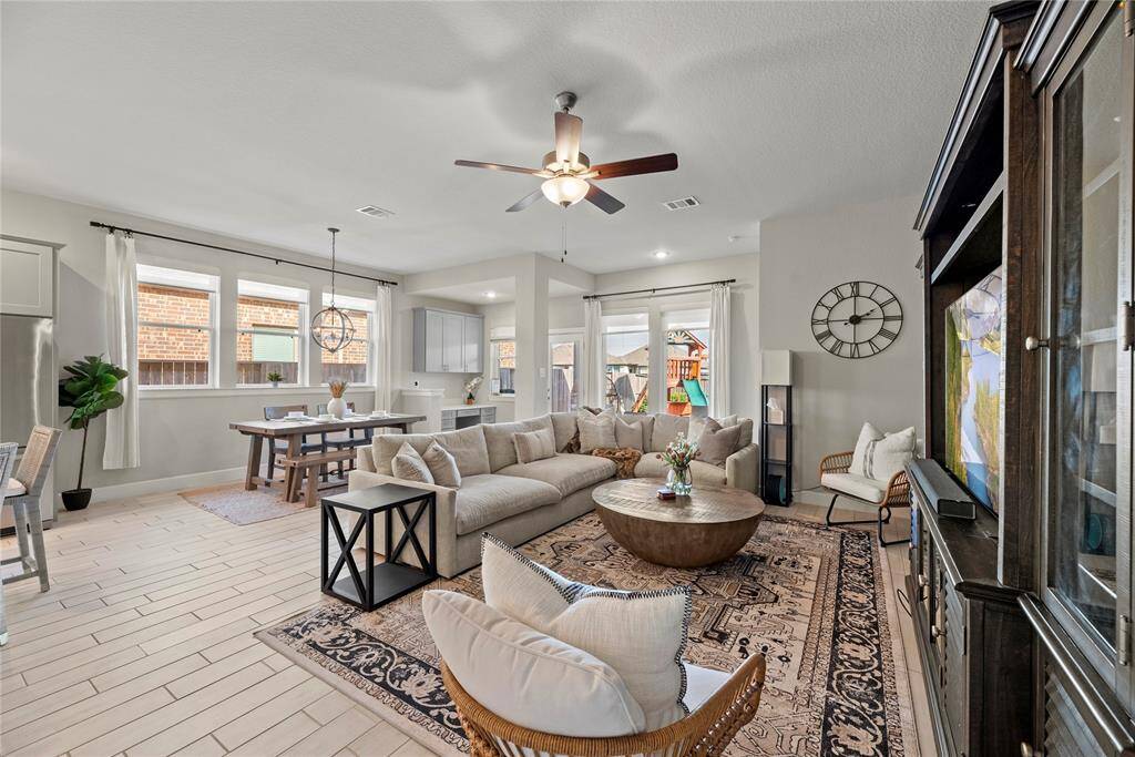 This chic living room space has a great feel with tons of natural light coming from all the windows.