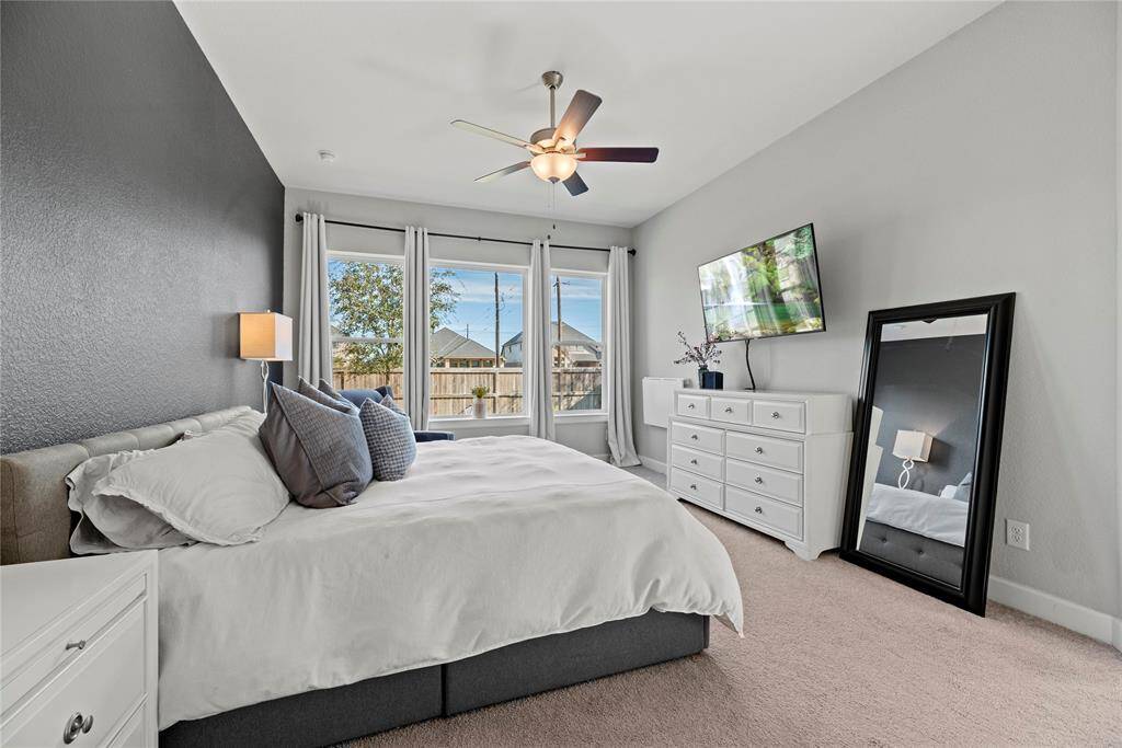 Now into your primary bedroom. Large windows overlooking your backyard lets in beautiful natural light to create a warm, comfortable space to relax and unwind.