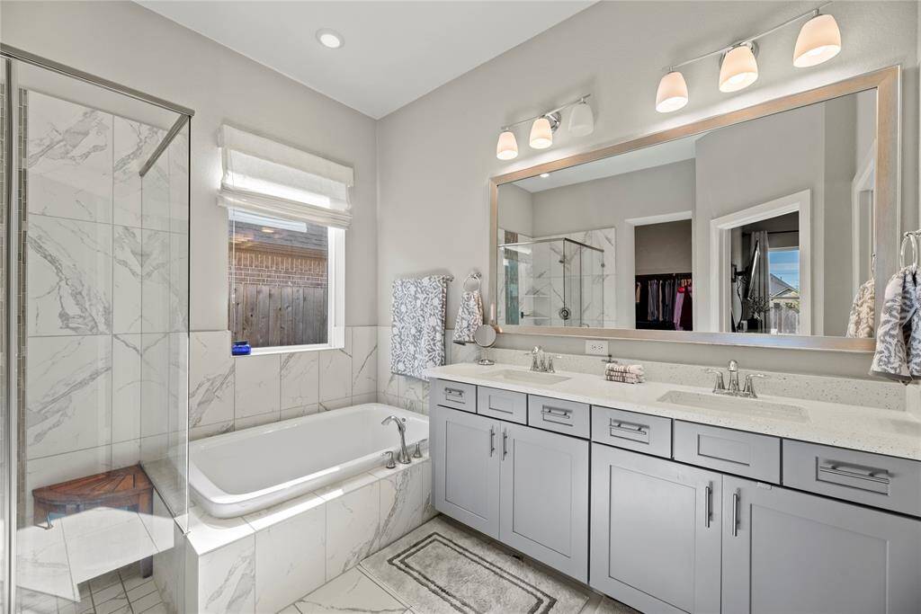 The soaking tub is a perfect space to sink in and relax.