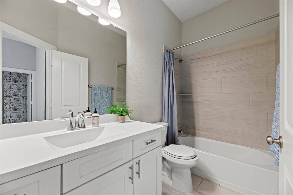 Your secondary bath with large vanity and plenty of storage.
