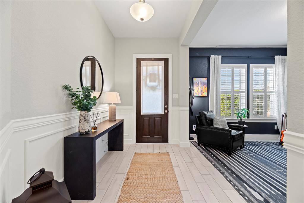 Beautifully installed wainscoting in the entrance adds to the designer feel of this home.