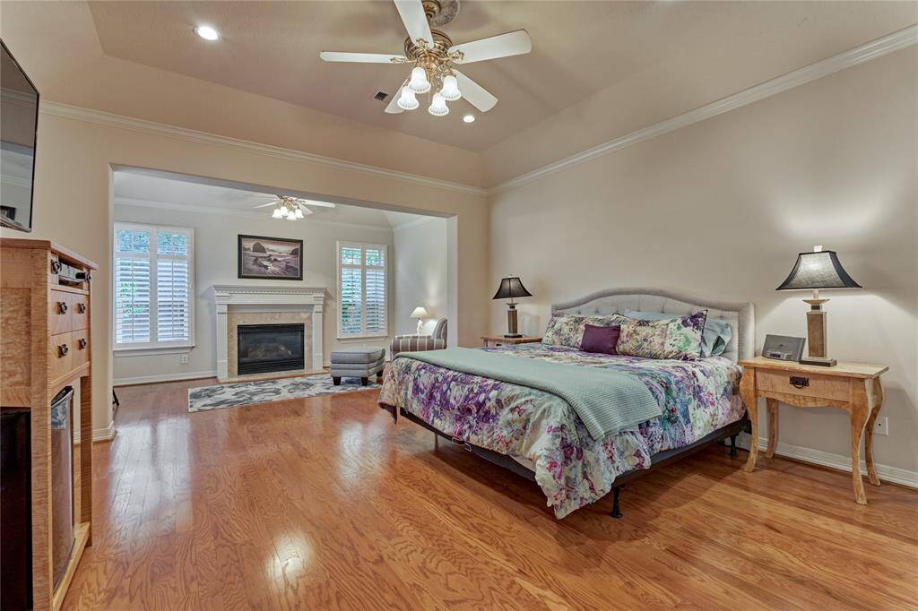 The primary suite is remarkable, featuring a gas log fireplace and a cozy sitting area.