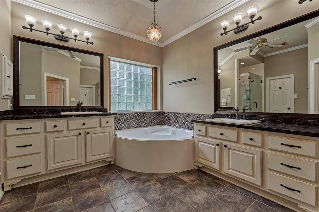 The main bathroom features dual sinks, a jetted tub, a vanity space, and TWO closets.