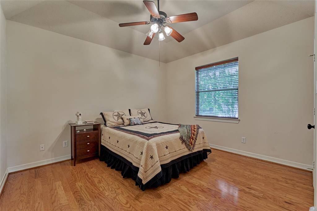 The first of the two secondary bedrooms with a walk-in closet.