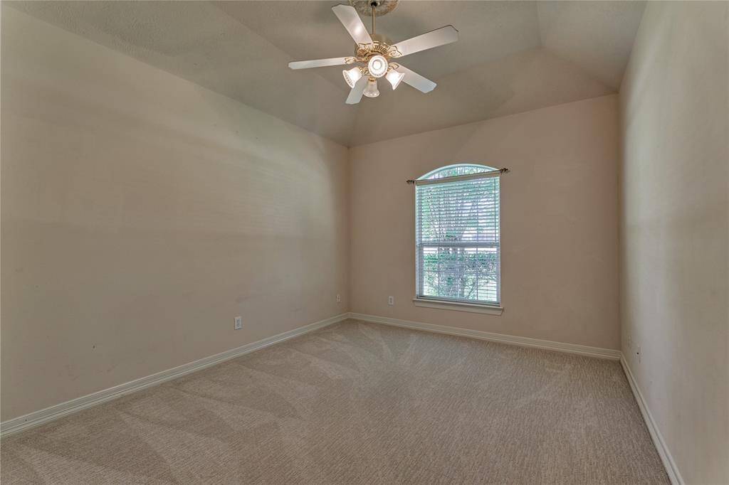 The second of the two secondary bedrooms with newly installed carpeting.