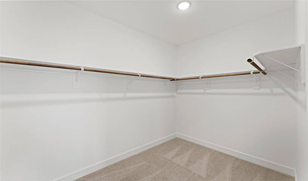 Walk-in closet in primary suite (*Photo not of actual home and used for illustration purposes only.)
