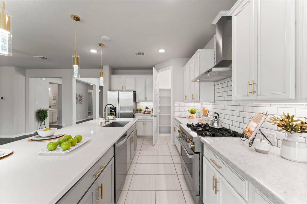 Stunning Kitchen, Quartz Countertops, Gold Accented Fixtures, 6 Burner Commercial Gas Range and Vent, Corner Pantry, Luxe Pendant Lighting and Undermount Lighting, Stainless Farm Sink and Dishwasher.