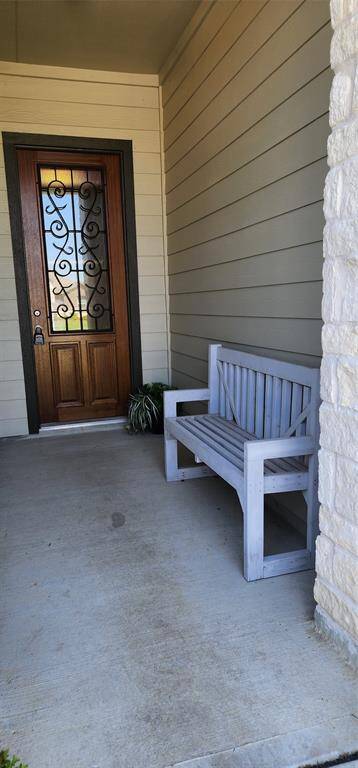 Large Covered Front Porch with Beautifully Adorned 8' Mahogony Front Door, Bench is also Included!