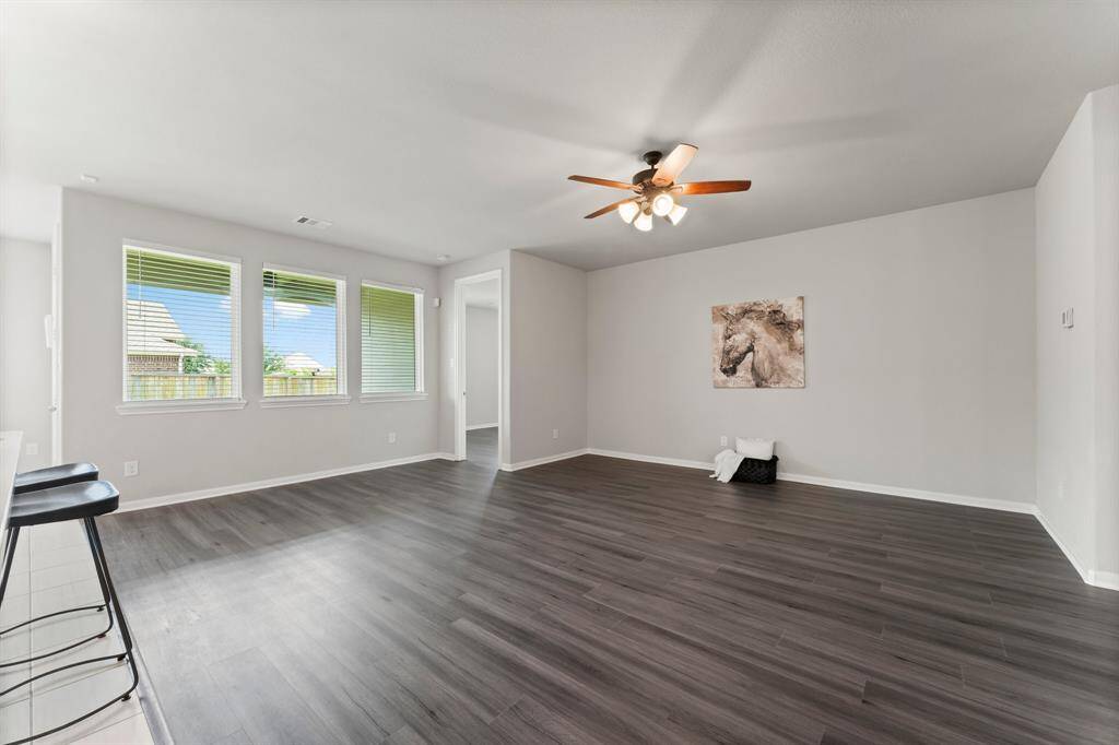 Spacious Living Room, Brand New LVP Flooring, Ceiling Fan and Views of Back Patio and Yard