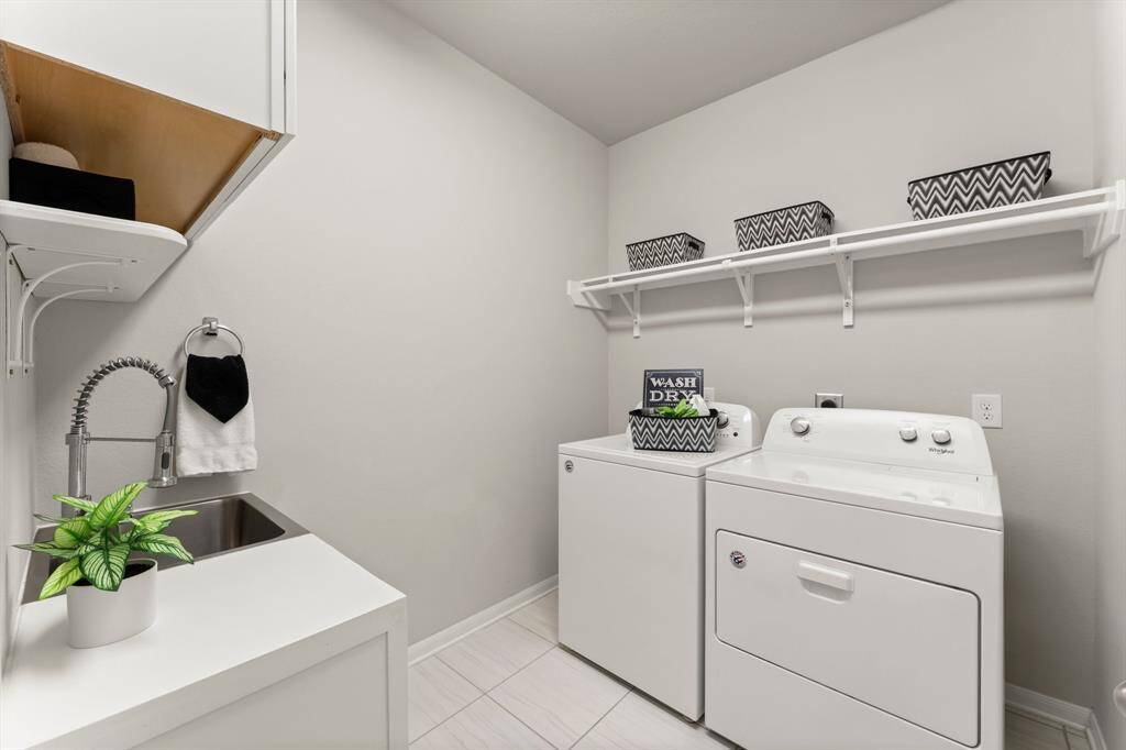 Utility Room Boasts Extra Cabinets and A Sink/Storage Area w/ Shelving, Tiled Flooring