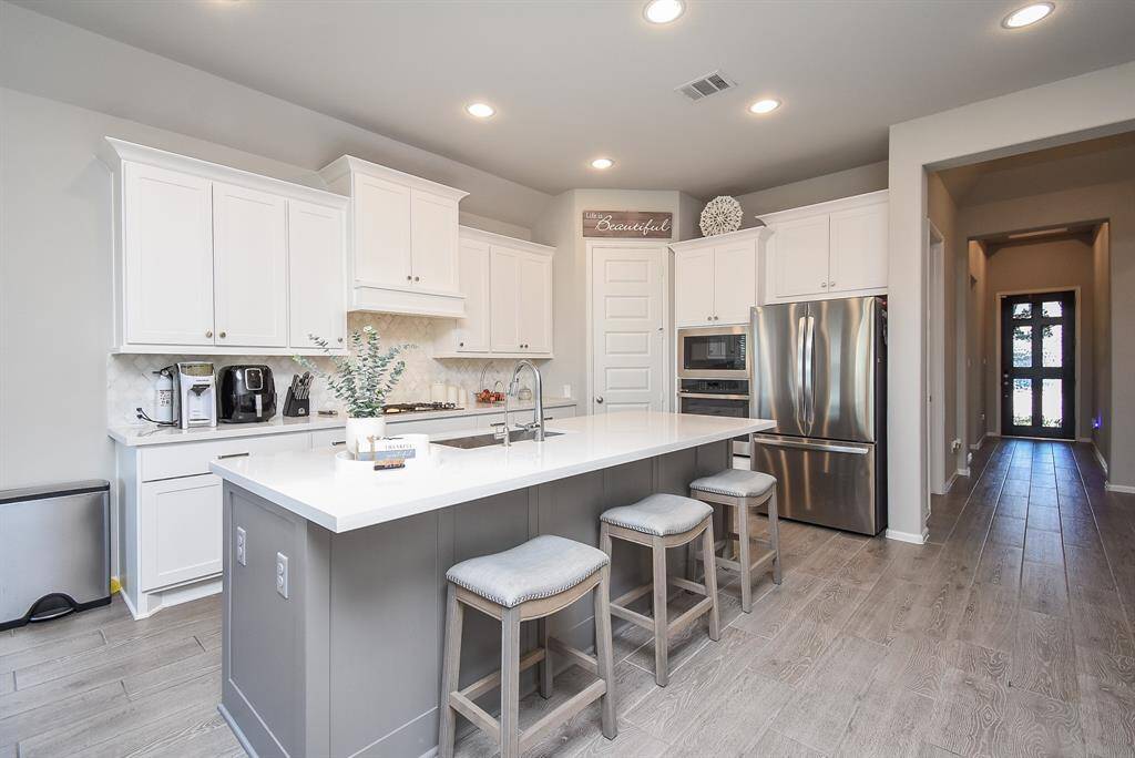 This photo shows the beautiful kitchen and grand entry.