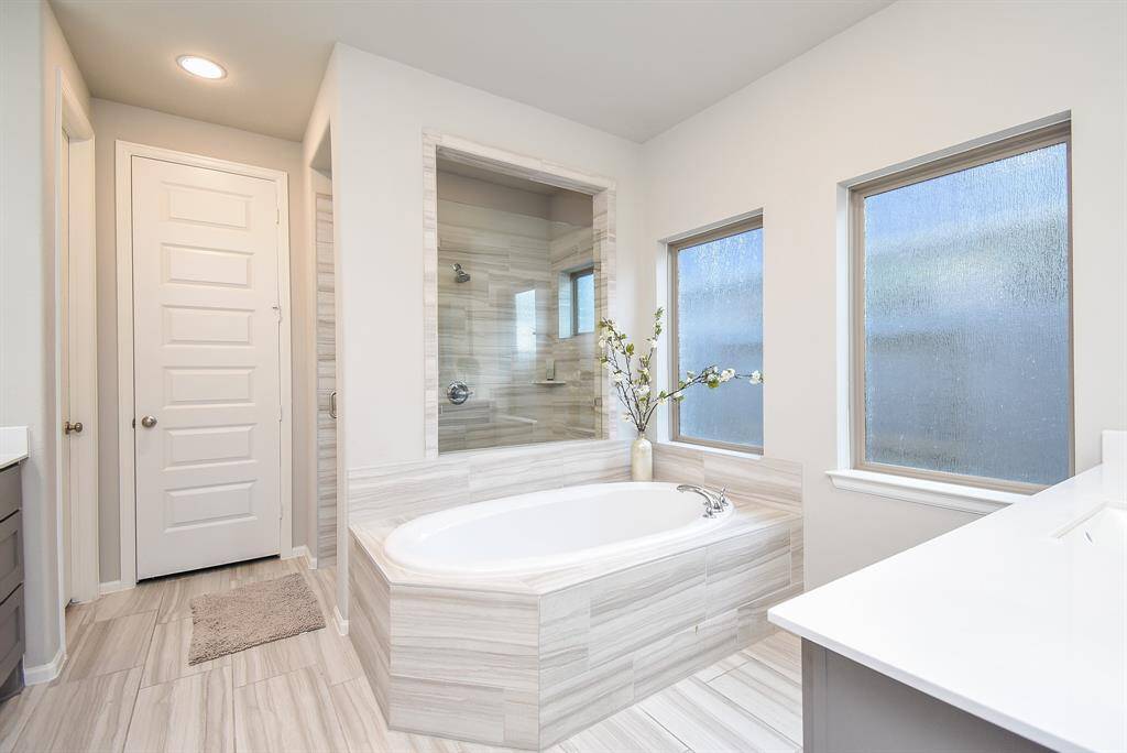 Soaking tub and upgraded oversized shower make this primary bath something to enjoy as your own at home spa feel experience