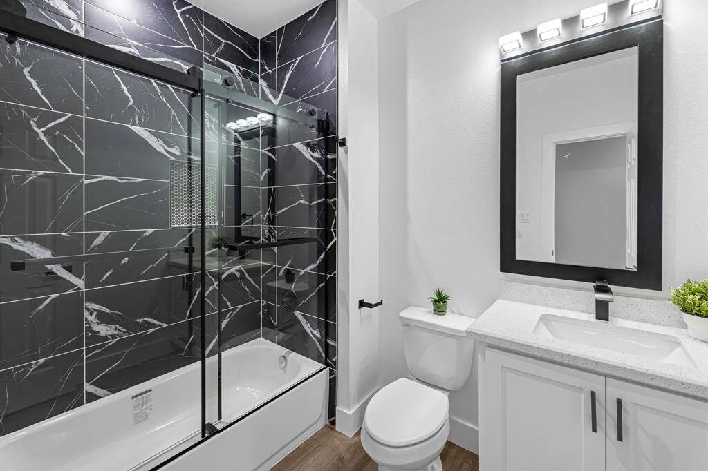 Bathroom #2 Hallway restroom. Tile shower, bathtub, granite countertops and modern fixtures. Mirrors were custom made.