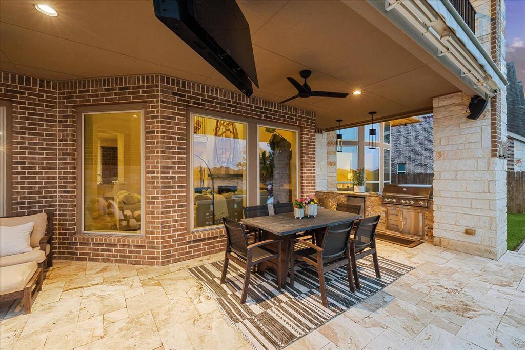 Covered patio underneath by the poolside to enjoty a nice dinner outside.
