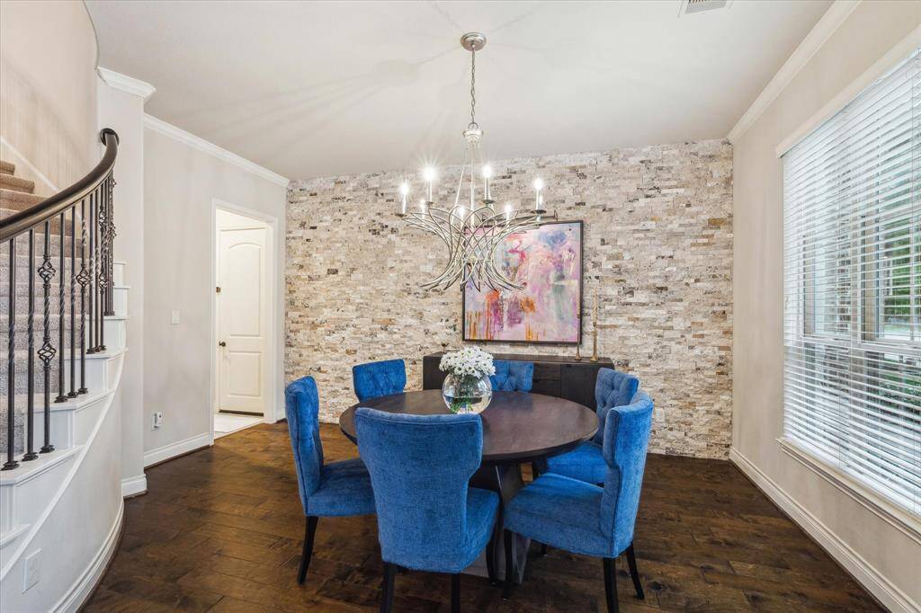 Formal dining room with custom travertine wall & chandelier to bighten the room.