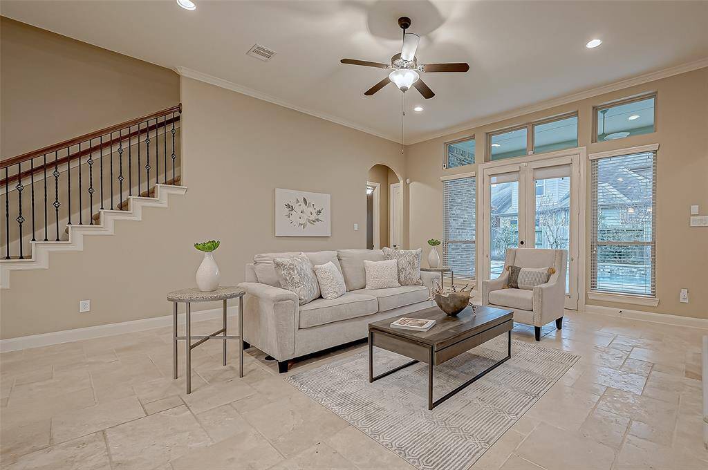Catch a glimpse of the graceful stairway leading to the spacious upstairs game room, while a charming alcove guides you to two additional guest bedrooms—perfect for comfort and privacy.