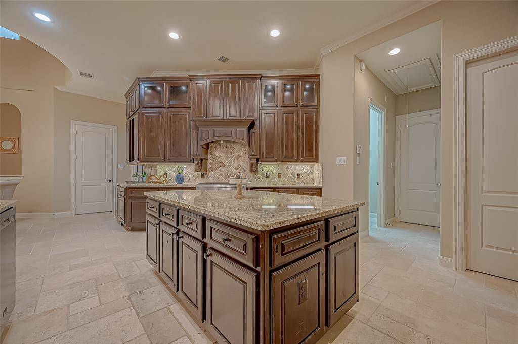 The island offers an incredible amount of storage—just the beginning of the thoughtful design in this impressive kitchen, where style meets functionality at every turn!