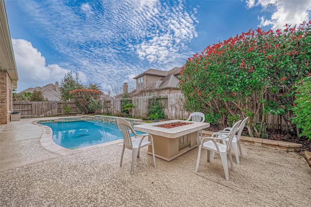 Enjoy your backyard oasis year-round with this inviting patio fire feature table, perfect for cozy gatherings and relaxed evenings under the stars.