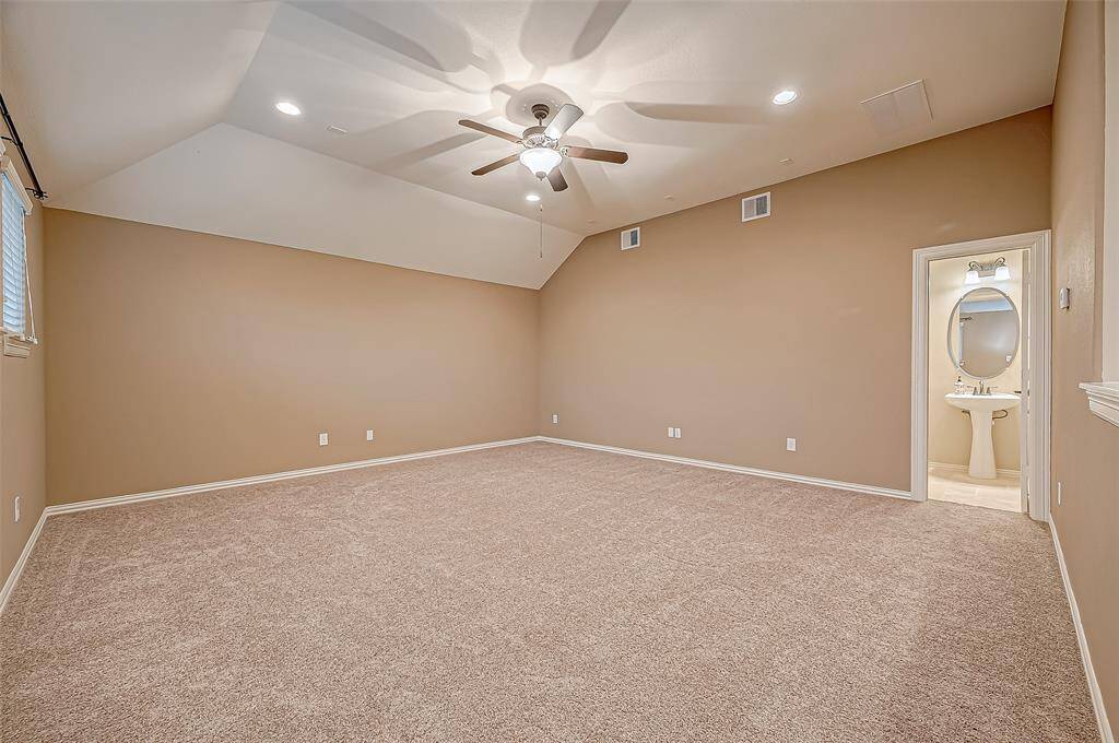 The spacious upstairs game room offers endless possibilities for fun and relaxation, complete with its own bathroom for added convenience.