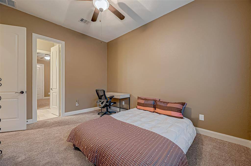 The second guest bedroom offers comfort and convenience with direct access to a Jack and Jill bathroom, making it a perfect retreat for family or guests.
