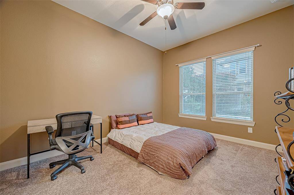 The second guest room offers a relaxing retreat with a ceiling fan for added comfort, large windows that fill the space with natural light, and a beautiful view of the pool!