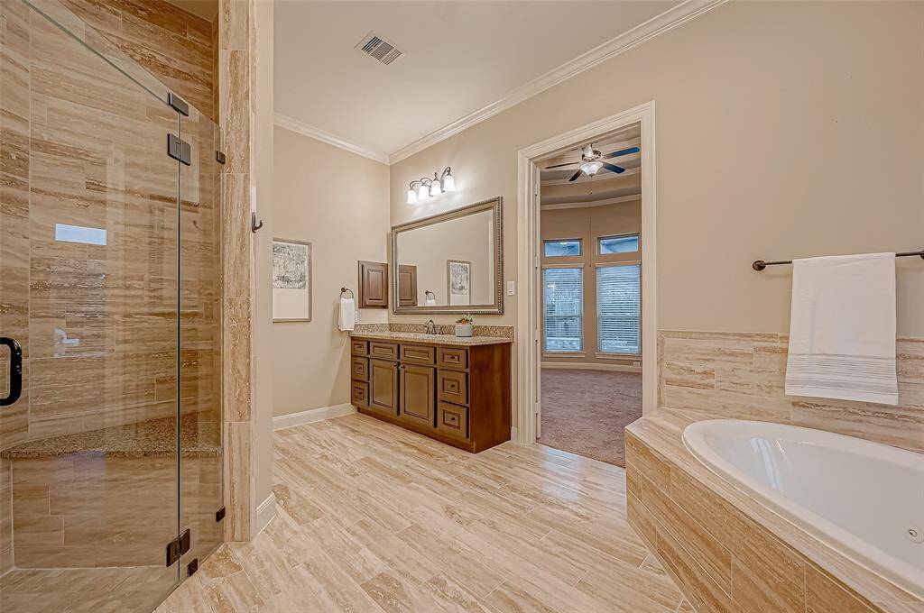 The expansive primary ensuite bathroom offers plenty of space to get ready with ease, featuring stylish finishes and a thoughtfully designed layout for ultimate comfort.