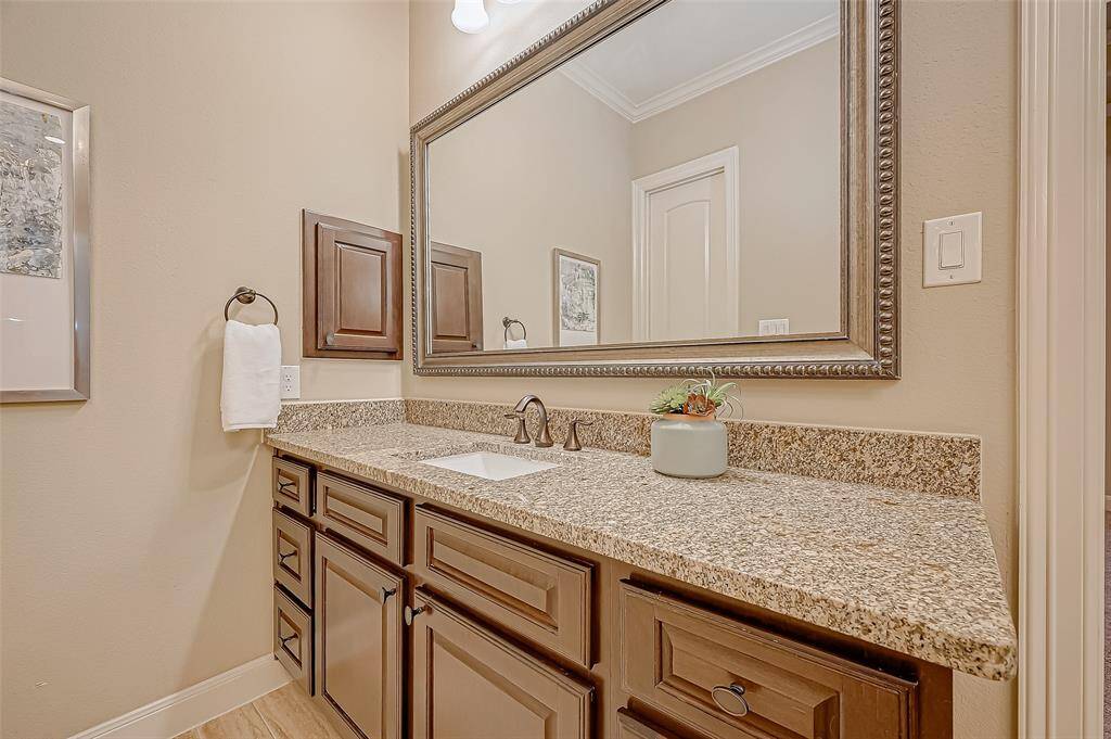 The second spacious vanity boasts a gorgeous granite countertop and abundant cabinet space, offering both style and functionality for effortless daily routines.