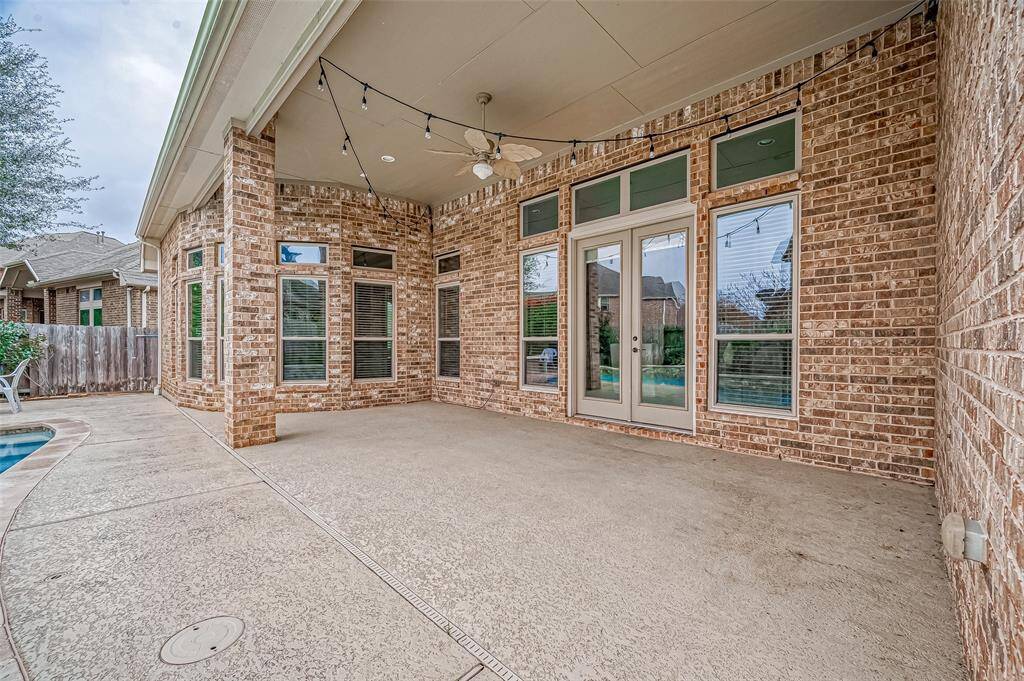 Step through your beautiful French doors onto the spacious covered patio, complete with a ceiling fan—perfect for relaxing or entertaining in comfort and style.