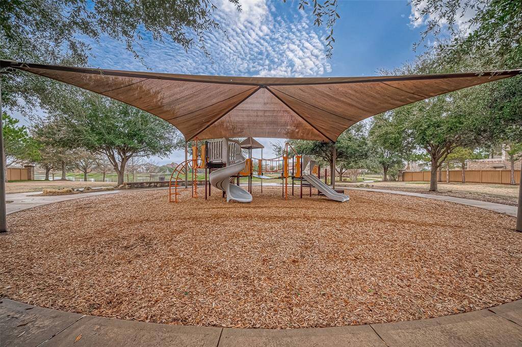 Take a short stroll to the neighborhood playground, thoughtfully covered for year-round fun and enjoyment for all ages.