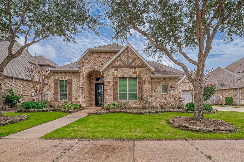 This gorgeous home by Village Builders boasts immense curb appeal, with stunning stonework on the front facade, beautifully complemented by charming shutters for the perfect finishing touch!