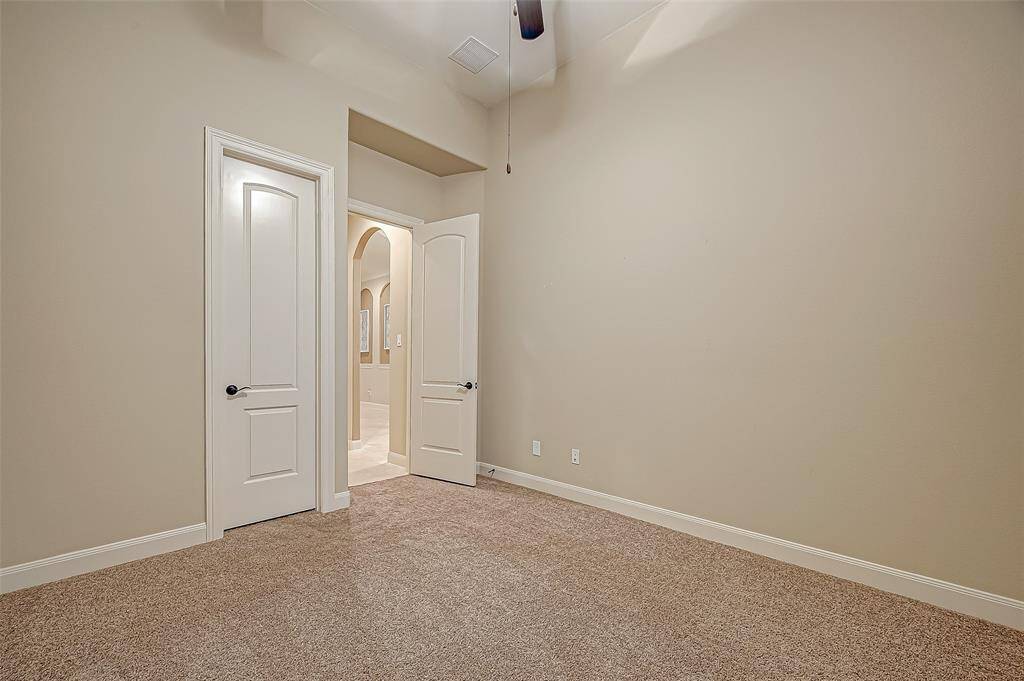 Located at the front of the home, the spacious guest bedroom offers privacy and comfort with a walk-in closet and its own ensuite bathroom—perfect for visitors!