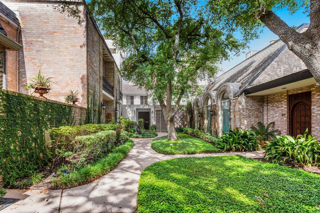 Gorgeous curb appeal with large black storm doors.