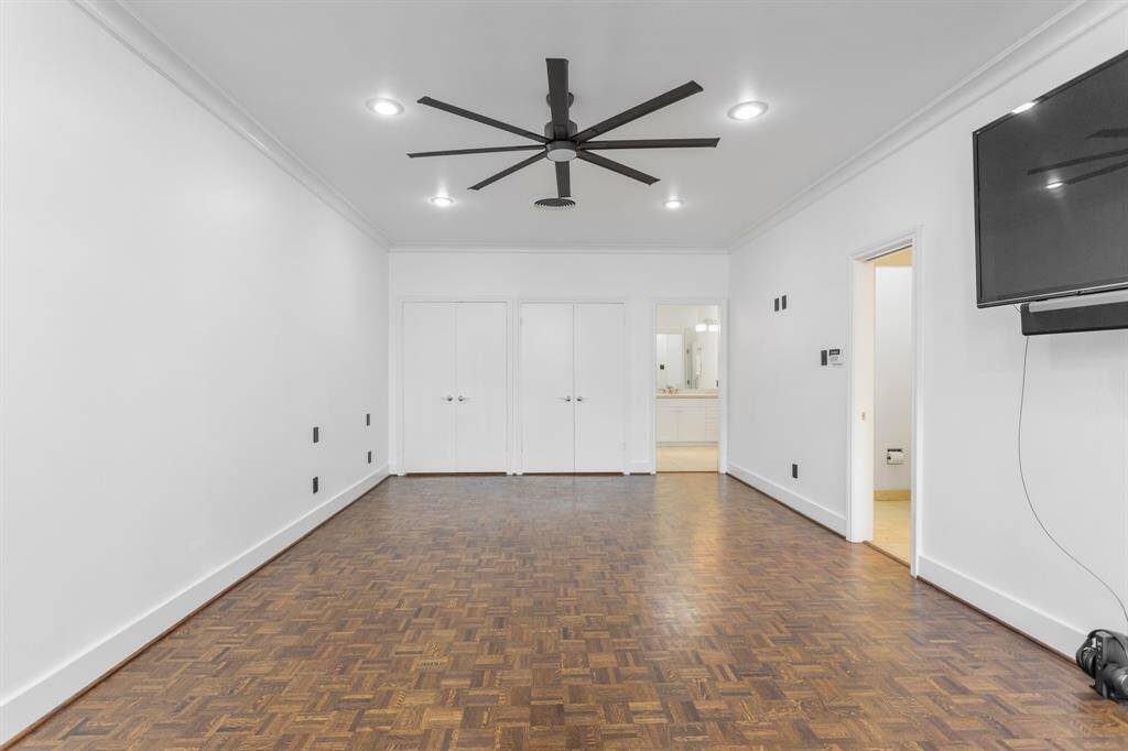 Oversized primary bedroom suite includes ensuite bath and two master closets with additional storage.