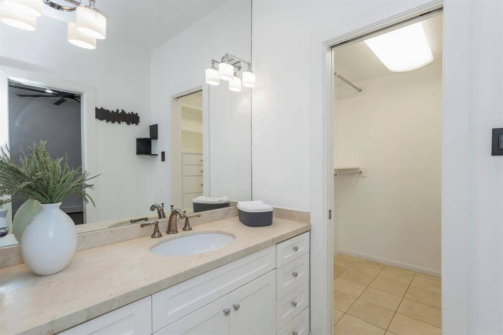 Primary bathroom includes custom cabinetry, separate bath tub and separate standing shower.