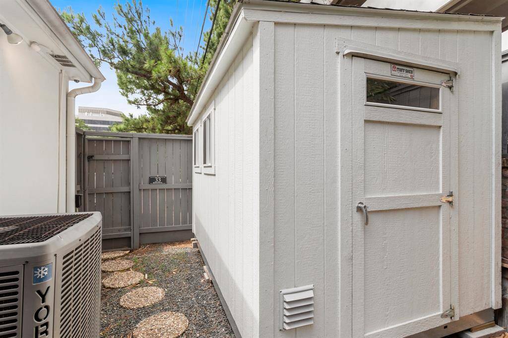 Lovely view of the back yard fully fenced offering an outdoor shed with electricity and AC.