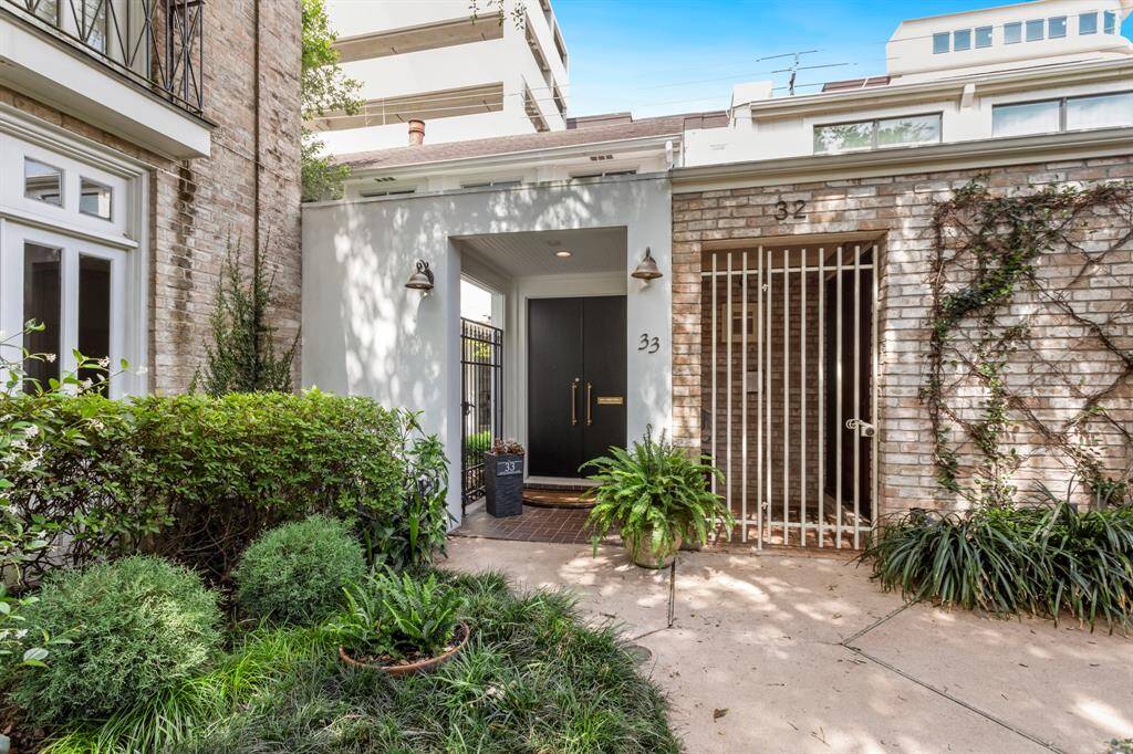 Gorgeous curb appeal with large black storm doors.