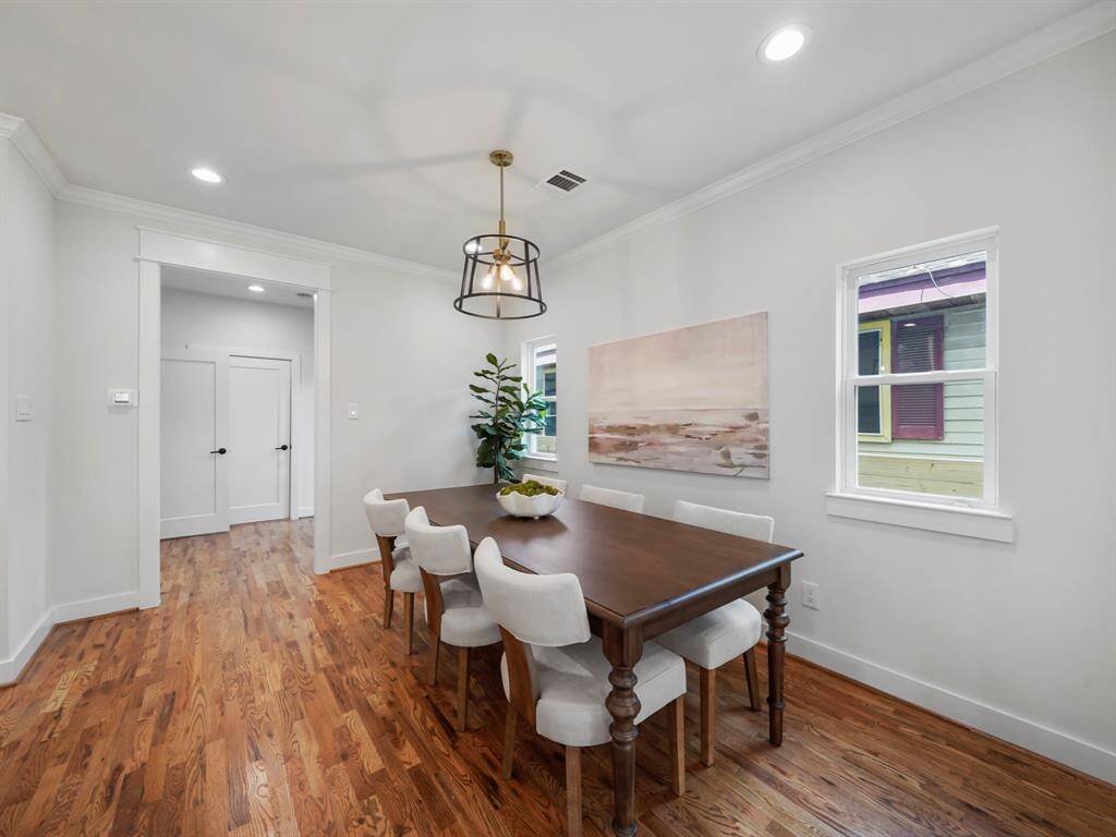 Elegant dining room featuring plenty of natural light and a seamless flow from the kitchen and living areas. The spacious layout offers a perfect setting for hosting dinner parties or enjoying everyday meals. Rich hardwood floors and stylish finishes complete this inviting space.