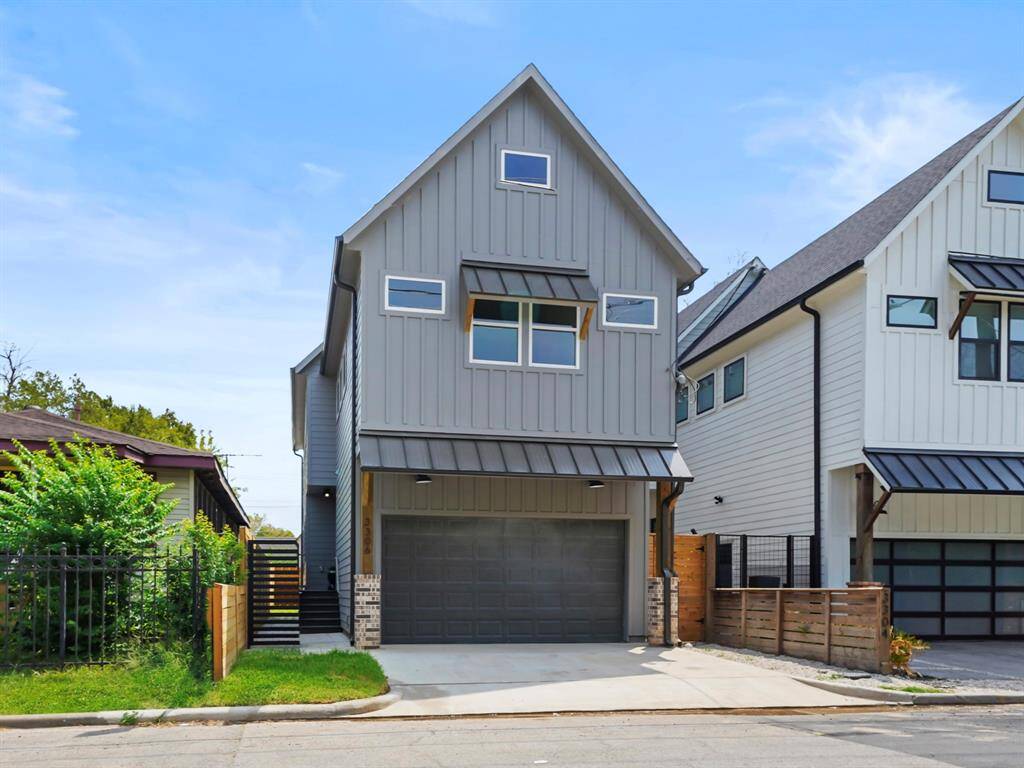 Stunning Craftsman-modern home with a sleek gray exterior, bold black garage door, and warm wood beam accents that add character and charm. The gated front entry provides both privacy and curb appeal, welcoming you into this beautifully designed residence. A perfect blend of modern elegance and timeless craftsmanship.