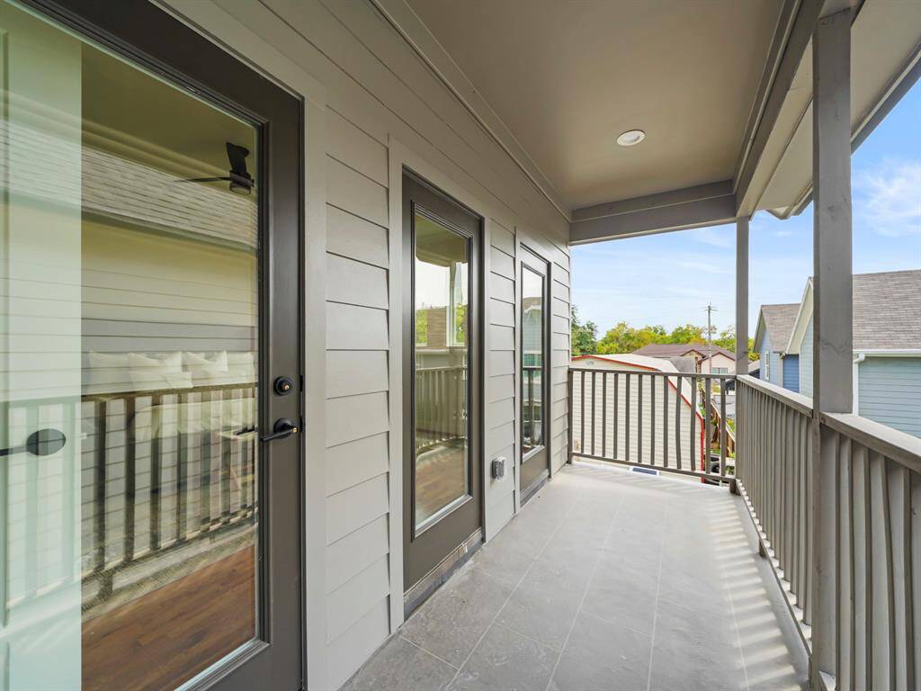 Private balcony off the primary bedroom, offering a serene outdoor retreat. Perfect for enjoying morning coffee or evening sunsets, this cozy space provides a tranquil setting with views of the surrounding area, adding an extra touch of luxury to the home.