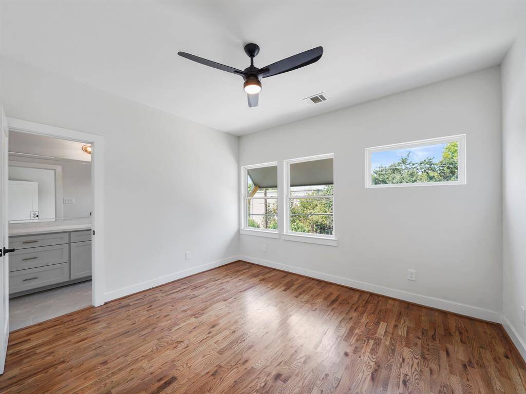 Bright and cozy secondary bedroom featuring ample space and natural light. This room shares a well-appointed Jack and Jill bathroom, offering convenience and privacy for guests or family members. Thoughtful design and ample closet space make this room both functional and comfortable.