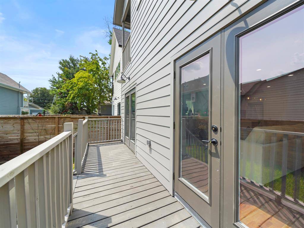 Spacious back porch, ideal for outdoor living and entertaining. Open to the sky, it offers a great space to relax, enjoy the fresh air, and take in the views of the backyard. The perfect spot for grilling, dining, or simply unwinding in a private setting.