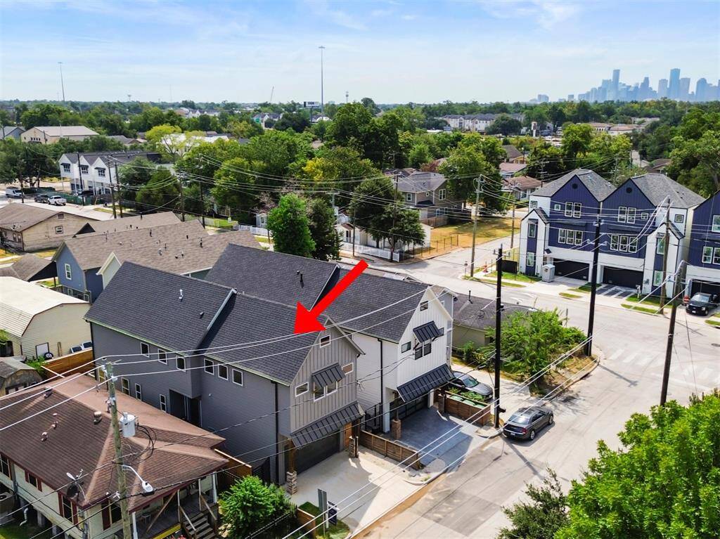 Aerial view of the exterior showcasing the home’s prime location, with easy access to downtown. The property is surrounded by new construction, highlighting the neighborhood’s growth and modern appeal. The layout emphasizes both urban convenience and suburban tranquility, offering the best of both worlds.