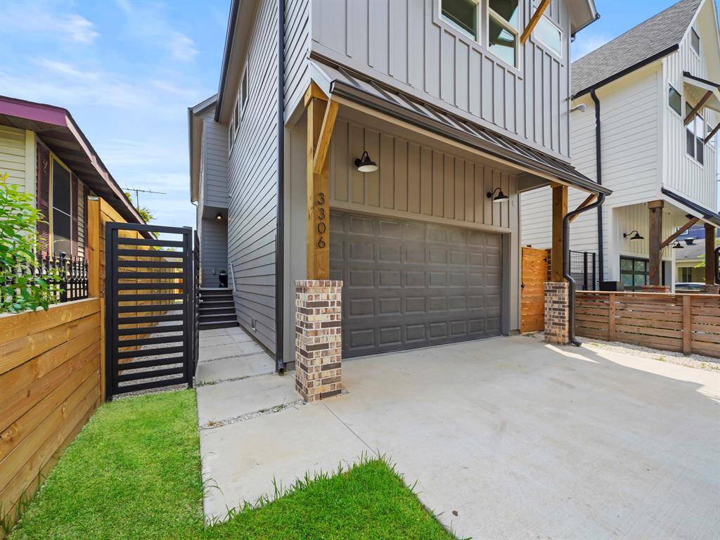 Stunning Craftsman-modern home with a sleek gray exterior, bold black garage door, and warm wood beam accents that add character and charm. The gated front entry provides both privacy and curb appeal, welcoming you into this beautifully designed residence. A perfect blend of modern elegance and timeless craftsmanship.
