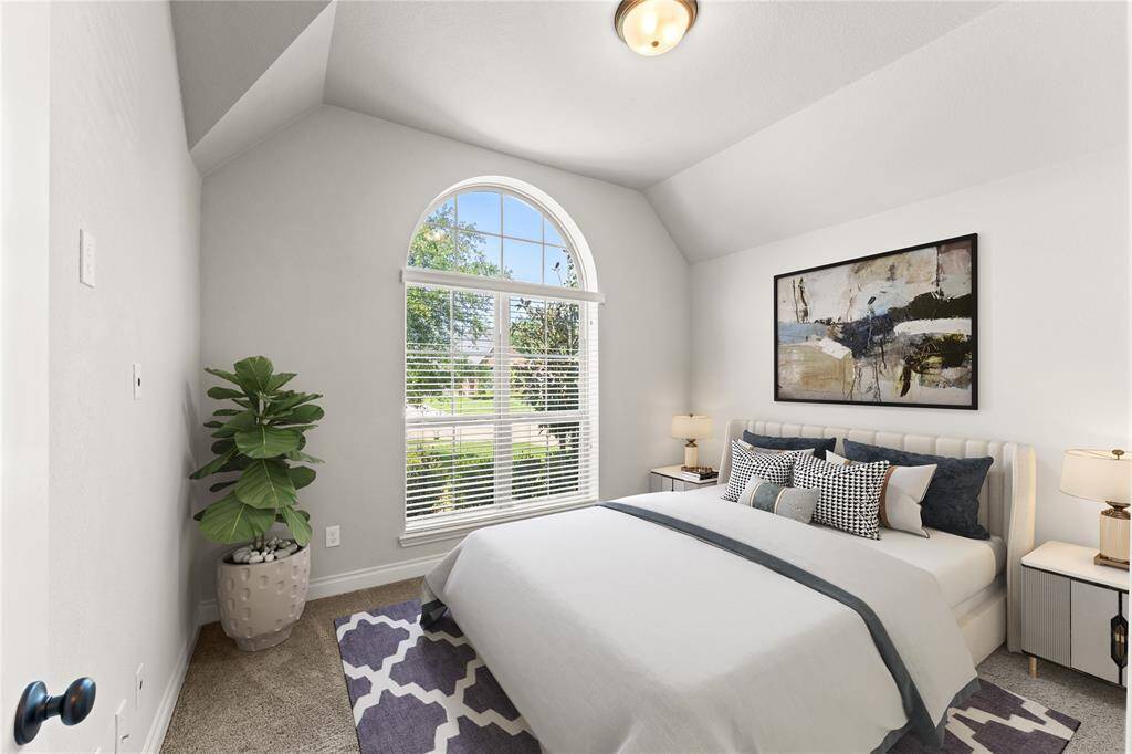 This second bedroom features warm tones and a spacious layout, perfect for a growing child or guest. A large window lets in the morning sun, making it a cheerful spot to wake up.