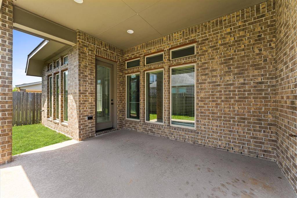 Step outside to a lovely covered patio—perfect for weekend BBQs or morning coffee.
