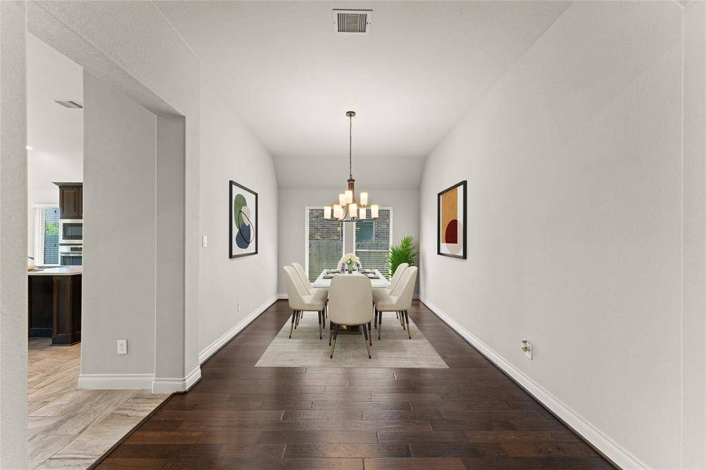 The formal dining room is bright and elegant, with a graceful chandelier.