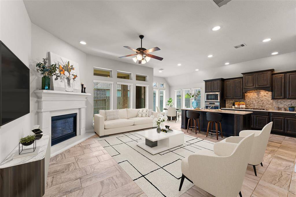 The living room is the heart of the home, with a cozy fireplace that adds warmth and charm.Natural light filters through the windows, brightening the space throughout the day.