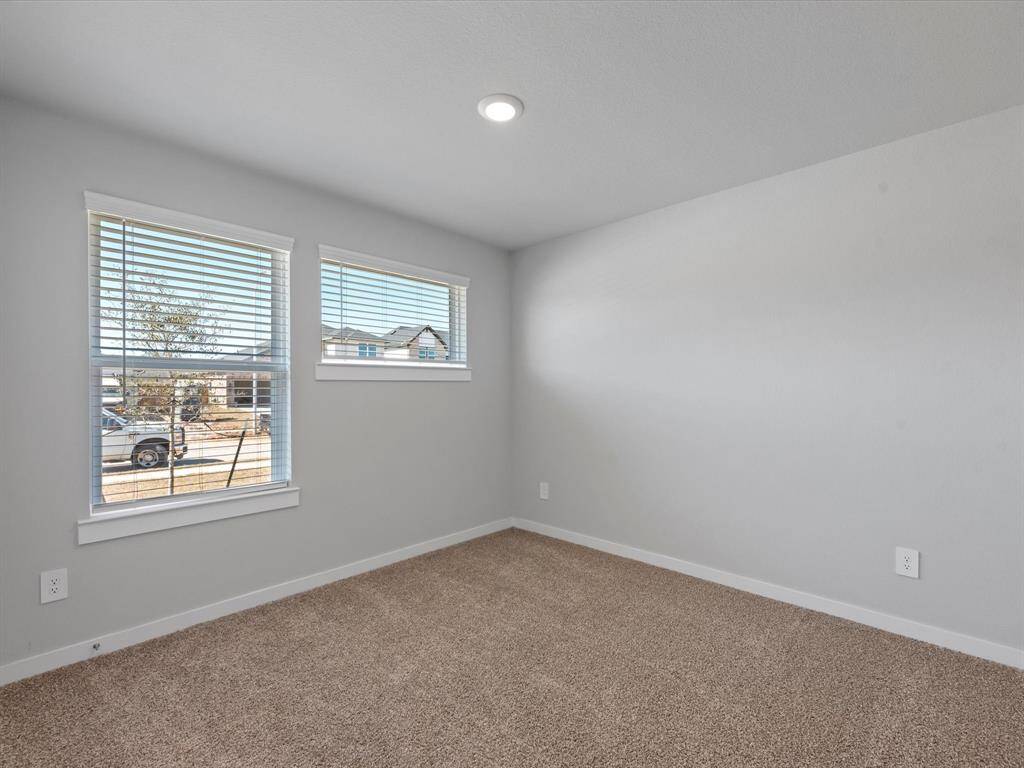 Bedroom #4 sits at front of home along w/ full bathroom